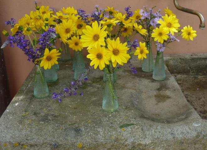 The little vases waiting to be placed on the tables